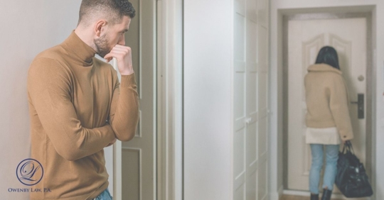 man watching as wife walks out the front door